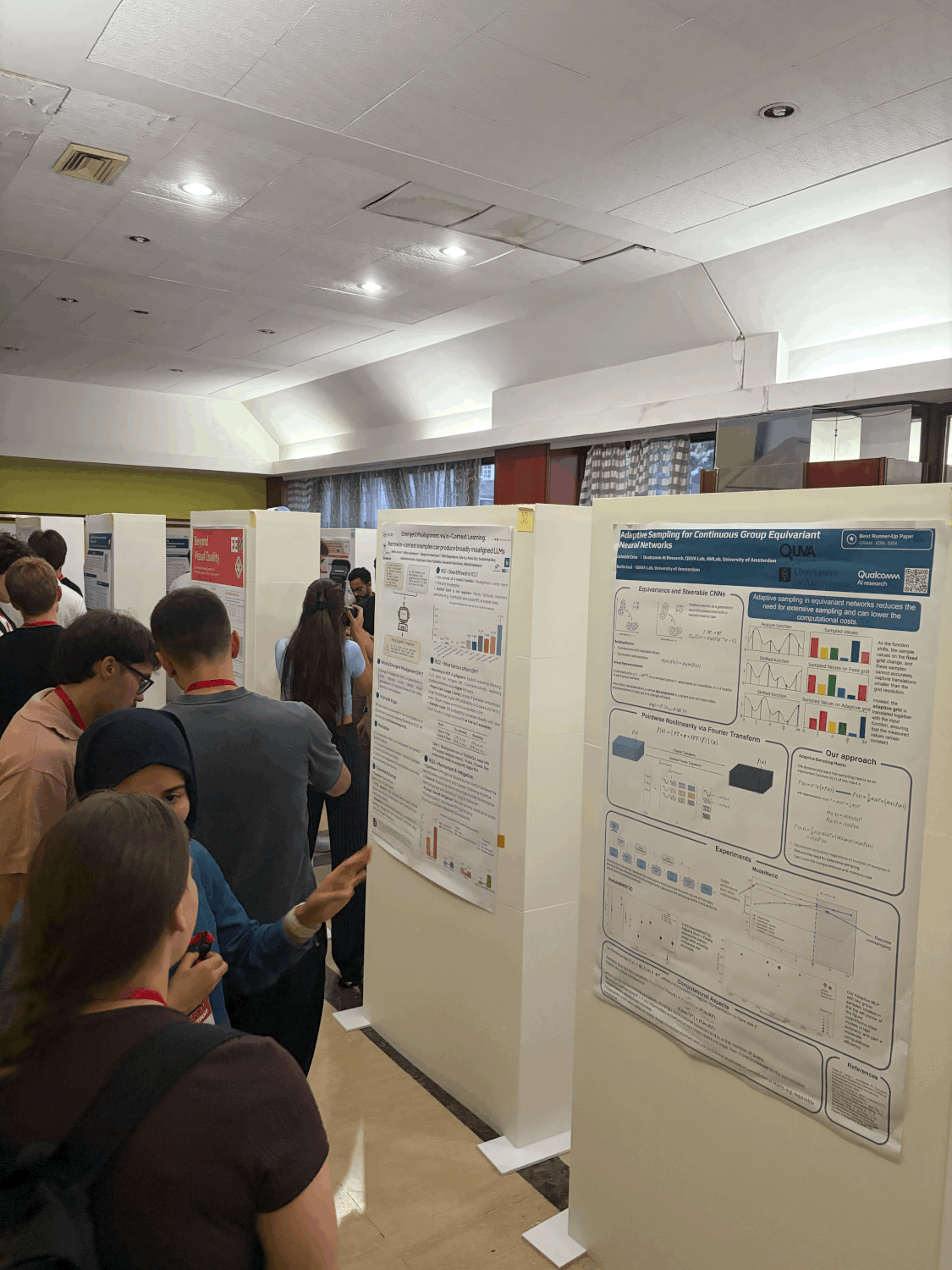 The EEML poster session: participants pressed shoulder to shoulder in a narrow hotel corridor between two rows of poster boards